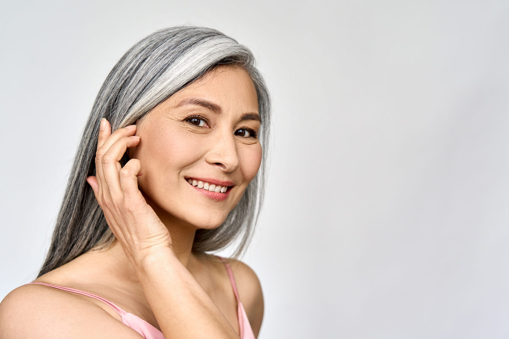 Woman with grey hair on grey background